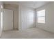 Neutral bedroom with carpeted flooring, closet, and a window at 4428 S Kalispell Cir, Aurora, CO 80015