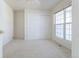 Neutral bedroom with a double window, closet, carpeted floors and natural light at 4428 S Kalispell Cir, Aurora, CO 80015