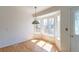 Bright dining area with hardwood floors, bay window, and ornate light fixture at 4428 S Kalispell Cir, Aurora, CO 80015