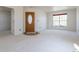 Entryway featuring a wood door with glass, neutral carpet, and a large window at 4428 S Kalispell Cir, Aurora, CO 80015