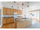 Open kitchen with granite countertops, center island, and stylish pendant lights at 4428 S Kalispell Cir, Aurora, CO 80015