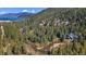 Aerial view of a home with a stream, lush forest, and nearby lake at 189 Ginger Quill Ln, Breckenridge, CO 80424