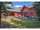 Backyard featuring a landscaped yard with a deck, an outdoor grill and rocking chairs at 189 Ginger Quill Ln, Breckenridge, CO 80424