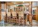 A well-designed kitchen bar featuring rustic wooden supports and decorative glass front cabinets at 189 Ginger Quill Ln, Breckenridge, CO 80424