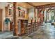 Well-appointed kitchen bar featuring wooden beam supports and decorative glass front cabinets at 189 Ginger Quill Ln, Breckenridge, CO 80424