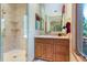 Bathroom featuring tiled walk-in shower, wood vanity, and ample counter space at 189 Ginger Quill Ln, Breckenridge, CO 80424
