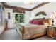 Cozy bedroom with wood beam ceiling, natural light, and decorative accents at 189 Ginger Quill Ln, Breckenridge, CO 80424
