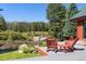 A cozy outdoor deck features wooden chairs, a small table, and a stunning mountain view at 189 Ginger Quill Ln, Breckenridge, CO 80424