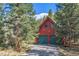A-frame home featuring a 2-car garage and forest surroundings at 189 Ginger Quill Ln, Breckenridge, CO 80424