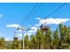 Gondola lift system in Breckenridge, Colorado surrounded by towering pine trees at 189 Ginger Quill Ln, Breckenridge, CO 80424