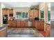 Traditional kitchen features knotty wood cabinets, granite counters, stainless steel appliances, and tile flooring at 189 Ginger Quill Ln, Breckenridge, CO 80424