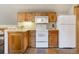 Functional kitchenette with wooden cabinetry, white appliances, and ample counter space, perfect for preparing light meals at 189 Ginger Quill Ln, Breckenridge, CO 80424