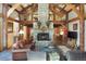 A rustic living room showcases vaulted ceilings, exposed beams, and a stone fireplace at 189 Ginger Quill Ln, Breckenridge, CO 80424