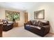 Comfortable living room with leather furniture, a window view, and a decorative mirror, creating a relaxing atmosphere at 189 Ginger Quill Ln, Breckenridge, CO 80424