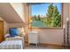 Bright seating area with a striped armchair and ottoman with a view of the surrounding mountains and trees at 189 Ginger Quill Ln, Breckenridge, CO 80424