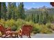 Mountain views from the outdoor deck with Adirondack chairs and a small table at 189 Ginger Quill Ln, Breckenridge, CO 80424