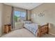 Cozy bedroom offers a large window view and a playful touch of artistic handprints on the wall at 21789 Farmingdale Way, Parker, CO 80138