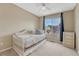 Bright bedroom featuring a daybed, complemented by a window offering neighborhood views at 21789 Farmingdale Way, Parker, CO 80138