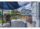Relax on this outdoor deck with chairs and an umbrella, overlooking the lawn and fenced backyard at 21789 Farmingdale Way, Parker, CO 80138