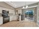 Bright eat-in kitchen with stainless steel appliances and sliding glass doors to the deck at 21789 Farmingdale Way, Parker, CO 80138