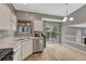 Stylish kitchen with stainless steel appliances and a view of the outdoor deck area at 21789 Farmingdale Way, Parker, CO 80138