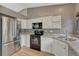 Clean kitchen with stainless steel refrigerator and stainless sink at 21789 Farmingdale Way, Parker, CO 80138
