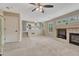 Expansive living room featuring a fireplace, leading to an open-concept kitchen area at 21789 Farmingdale Way, Parker, CO 80138