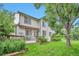 The beautiful back of the house features a deck and awning with views of the lawn and lush garden at 18852 E Progress Ave, Centennial, CO 80015
