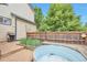 Backyard with wooden fence, foliage, an outdoor grill, and a metal stock tank pool at 18852 E Progress Ave, Centennial, CO 80015