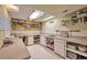 Basement space with utility sink, cabinets, ample counter space, and lighting at 18852 E Progress Ave, Centennial, CO 80015