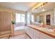 Bathroom boasts a tub, shower, double sinks, and a large mirror for added convenience and space at 18852 E Progress Ave, Centennial, CO 80015
