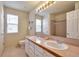 Spacious bathroom with double sinks, a large mirror, and a shower/tub combo, offering functionality and style at 18852 E Progress Ave, Centennial, CO 80015