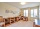 Versatile bedroom or office space with built-in shelving and a comfortable seating area at 18852 E Progress Ave, Centennial, CO 80015