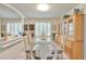 Elegant dining room featuring a large table, custom cabinetry, and ample natural light from shuttered windows at 18852 E Progress Ave, Centennial, CO 80015