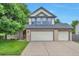 Charming two-story home featuring a three-car garage, manicured lawn and covered porch, perfect for curb appeal at 18852 E Progress Ave, Centennial, CO 80015