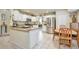 Bright and spacious kitchen with white cabinets, granite countertops, and a cozy breakfast nook area with ample space at 18852 E Progress Ave, Centennial, CO 80015