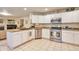 Well-equipped kitchen with white cabinets, stainless steel appliances, and granite countertops, perfect for culinary enthusiasts at 18852 E Progress Ave, Centennial, CO 80015