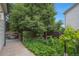 View of the side yard with a concrete path and garden beds, a tranquil outdoor space at 18852 E Progress Ave, Centennial, CO 80015