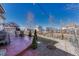 Backyard featuring a patio with lights and a firepit, a fenced yard, and rock landscaping at 13903 Hillsboro Dr, Parker, CO 80134