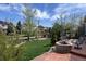 Landscaped backyard features a stone firepit and outdoor seating perfect for entertaining at 13903 Hillsboro Dr, Parker, CO 80134