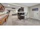Basement featuring a bar with seating, dark wood shelving and gray carpet at 13903 Hillsboro Dr, Parker, CO 80134