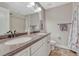 Bathroom with double sinks, white cabinets, and neutral colors at 13903 Hillsboro Dr, Parker, CO 80134