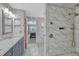 Modern bathroom featuring marble tile, dual shower heads, and luxurious vanity with granite countertops at 13903 Hillsboro Dr, Parker, CO 80134