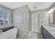 Modern bathroom with white marble tile, soaking tub, and stylish vanity at 13903 Hillsboro Dr, Parker, CO 80134