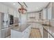 Open kitchen with granite counters, stainless steel appliances, island and white cabinets at 13903 Hillsboro Dr, Parker, CO 80134