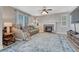 Cozy living room with a stone fireplace, ceiling fan, and stylish area rug at 13903 Hillsboro Dr, Parker, CO 80134