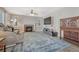 Inviting living room featuring a stone fireplace, ceiling fan, and custom cabinets at 13903 Hillsboro Dr, Parker, CO 80134