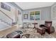 Cozy living room with comfortable seating, a decorative rug, and bright windows at 13903 Hillsboro Dr, Parker, CO 80134