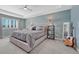 Serene main bedroom with a tray ceiling, plantation shutters, and soft carpet at 13903 Hillsboro Dr, Parker, CO 80134