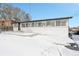 Back exterior showcasing the property's well-lit sunroom and clean white brick at 9040 Yucca Way, Thornton, CO 80229